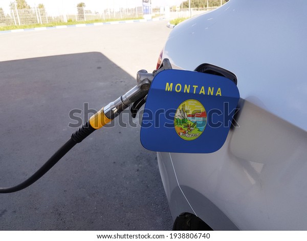 Flag of Montana on the\
car\'s fuel tank filler flap. Petrol station. Fueling car at a gas\
station.