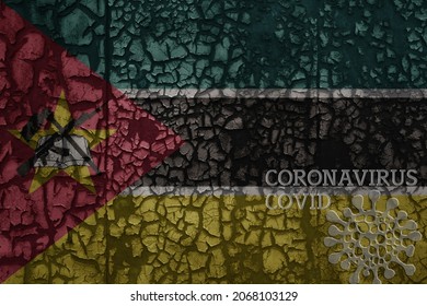 Flag Of Mozambique On A Old Vintage Metal Rusty Cracked Wall With Text Coronavirus, Covid, And Virus Picture.