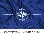 Flag of NATO on silk. Waving flag of NATO.  NATO flag as a background.