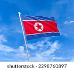 Flag on North-Korea flag pole and blue sky, Flag of North-Korea fluttering in blue sky big national symbol. Waving white blue  and red star North-Korea flag, Independence Constitution Day.