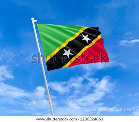 Flag on Saint-Kitts-and-Nevis flag pole and blue sky, Flag of Saint-Kitts fluttering in blue sky big national symbol. Waving dark red and green Saint-Kitts state flag, Independence Constitution Day.