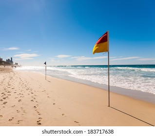 Flag On The Surfers Paradise Beach In Gold Coast, Australia.