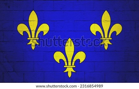 Flag of Île-de-France painted on a cinder block wall.