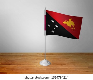 Flag of Papua New Guinea Table. Papua New Guinea Desk Flag on Wooden Table.