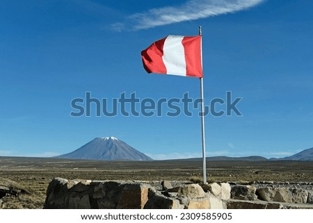 Flag of Peru with the background of the Misti volcano in Arequipa.