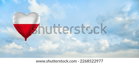 Flag of Poland on heart-shaped balloon against sky clouds background. Education, charity, emigration, travel and learning. Polish language concept