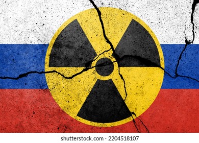 Flag Of Russia Painted On A Concrete Wall With Nuclear Weapon Sign. Russian Military Aggression