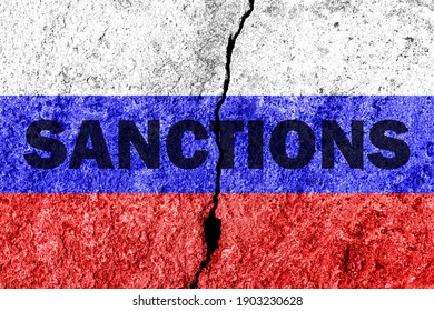 The flag of the Russian Federation on a cracked concrete wall with the words "SANCTIONS". Concept of sanctions against Russia. - Shutterstock ID 1903230628