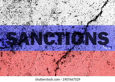 The flag of the Russian Federation on a cracked concrete wall with the words "SANCTIONS". Concept of sanctions against Russia. - Shutterstock ID 1907667529