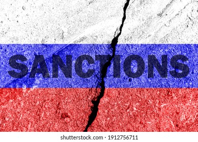 The flag of the Russian Federation on a cracked concrete wall with the words "SANCTIONS". Concept of sanctions against Russia. - Shutterstock ID 1912756711