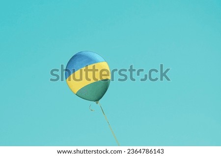 Flag of Rwanda flags Ballon on Blue Sky. Rwanda Flag painted on Ballon for politics, economy, election.