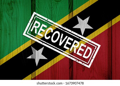 flag of Saint Kitts and Nevis that survived or recovered from the infections of corona virus epidemic or coronavirus. Grunge flag with stamp Recovered