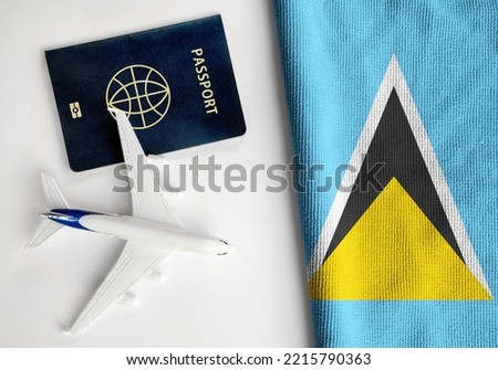 Flag of Saint Lucia with passport and toy airplane. Flight travel concept 