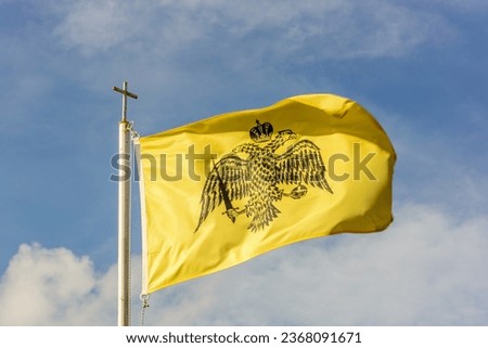 The flag showing the two head eagle is waving
