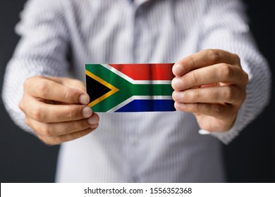 The Flag Of South Africa. Close-up Of Man Holding South African Flag.