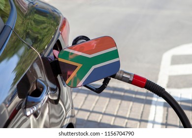 Flag Of South Africa On The Car's Fuel Tank Filler Flap. Fueling Car With Petrol Pump At A Gas Station. Petrol Station. Gasoline And Oil Products. Close Up.