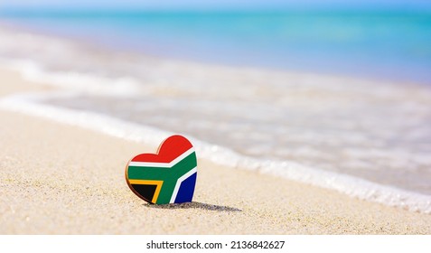 Flag of South Africa in the shape of a heart on a sandy beach. The concept of the best vacation in South Africa. - Shutterstock ID 2136842627