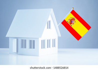 Flag Of Spain On The Roof Of The Layout Of The Cottage.. Buy Timeshare In Spain. Accommodation In Europe. Acquisition Of Real Estate In Madrid. Emigration. Move.