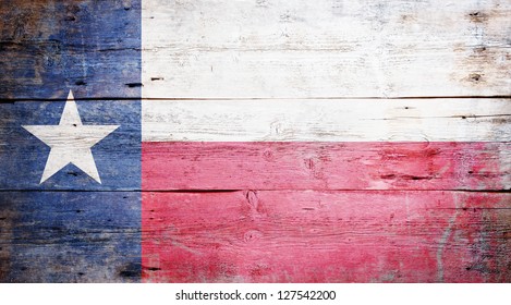 Flag of the State of Texas painted on grungy wooden background