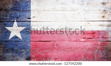 Flag of the State of Texas painted on grungy wooden background