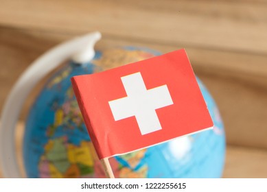 Flag of Switzerland and a globe - Shutterstock ID 1222255615