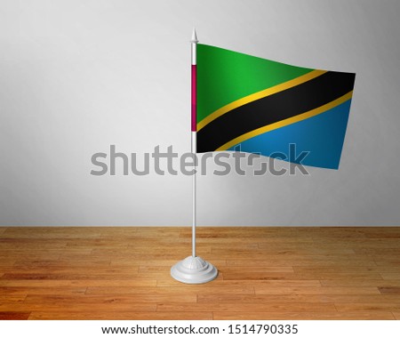 Flag of Tanzania Table. Tanzania Desk Flag on Wooden Table.