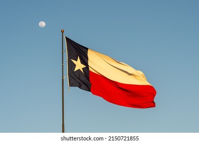 Flag Of Texas Waving In The Wind With Blue Sky In Background. Texas Is A State In The South Central Region Of The United States.