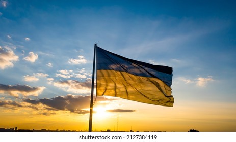 Flag of Ukraine against the backdrop of sunrise. Yellow-blue flag of independent Ukraine.
 - Shutterstock ID 2127384119