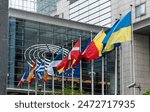 Flag of Ukraine, European Union and EU members in front of the European Parliament buildings in Brussels. Representing the unity and support between Ukraine and the EU, especially in the context of