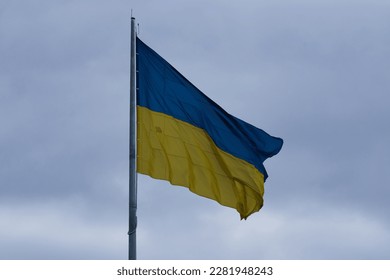 Flag of Ukraine that is developing against the background of cloudy skies - Shutterstock ID 2281948243
