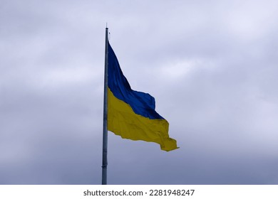 Flag of Ukraine that is developing against the background of cloudy skies - Shutterstock ID 2281948247