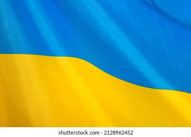 Flag of Ukraine, UA. Blue and yellow colors. Close up shot, background - Shutterstock ID 2128962452