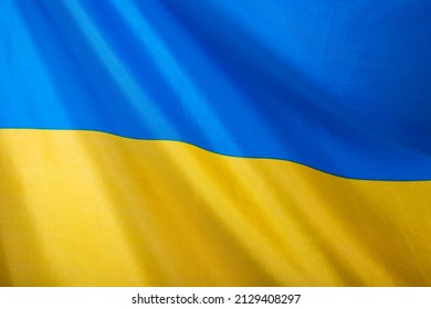 Flag of Ukraine, UA. Blue and yellow colors. Close up shot, background - Shutterstock ID 2129408297