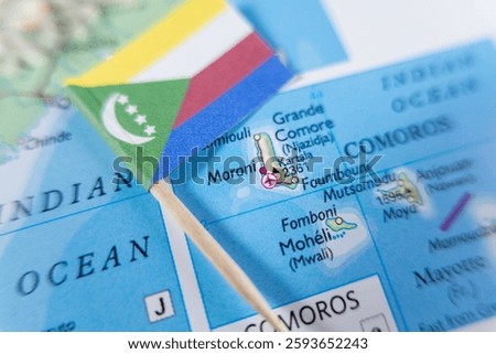 flag of the union of the comoros marking moroni on map, located in the indian ocean between africa and madagascar, showcasing the archipelago’s geographic position