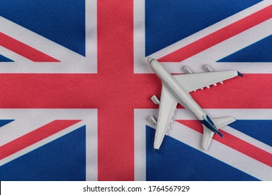 Flag Of United Kingdom And Toy Airplane. Air Travel In UK. Resuming Flights After Quarantine.