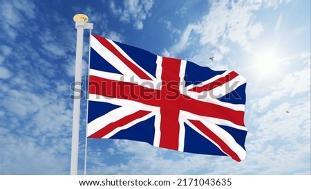 Flag of United Kingdom waving in the wind, sky and sun background. United Kingdom Flag.
