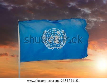 Flag of the United Nations. United Nations flag on sky background. UN symbol.