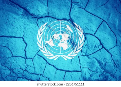 Flag of the United Nations. United Nations flag. UN symbol. Flag on the background of dry cracked earth  Flag with drought concept