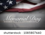 The flag of the United Sates of America on a grey plank background with memorial day