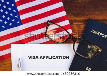 Flag of United State , visa application form and passport on table