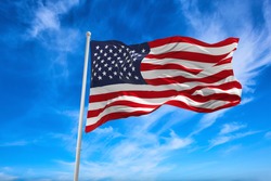 Flag Of United States Of America Being Waved In The Breeze Against A Sunset Sky.. US Flag