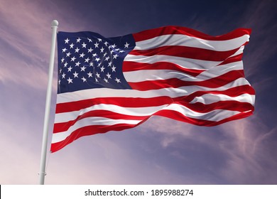 Flag of United States of America being waved in the breeze against a sunset sky.