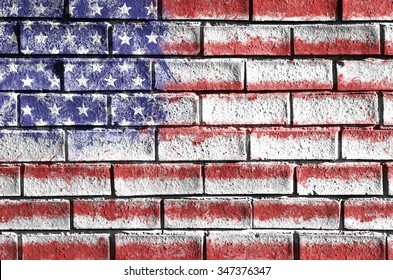 Flag of the United States of America painted onto a grunge brick wall. USA flag.
