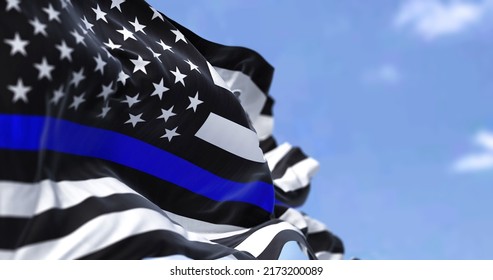 The flag of the United States of America in the Thin Blue Line variant waving in the wind. The 