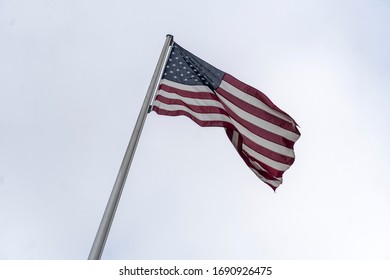 Flag Of The United States, American Flag Or U.S. Flag Waving Against A Cloudy Sky