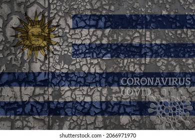 Flag Of Uruguay On A Old Vintage Metal Rusty Cracked Wall With Text Coronavirus, Covid, And Virus Picture.