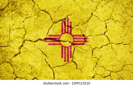 Flag Of The U.S. State Of New Mexico On Dry Earth Ground Texture Background