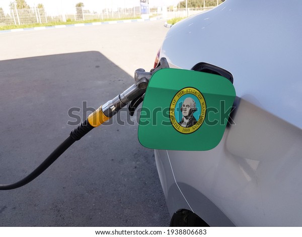 Flag of Washington on the\
car\'s fuel tank filler flap. Petrol station. Fueling car at a gas\
station.