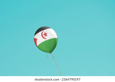 Flag of Western Saharaflags Ballon on Blue Sky. Western Sahara Flag painted on Ballon for politics, economy, election.