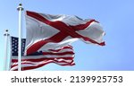 The flags of the Alabama state and United States of America waving in the wind. Democracy and independence. American state.